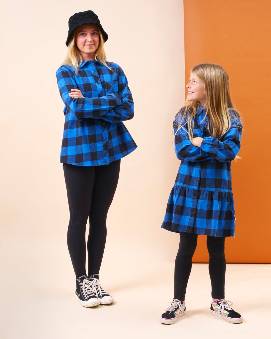 A girl and a boy dressed in a stylish Saltrock Birdie - Girls Check Shirt Dress - Blue.
