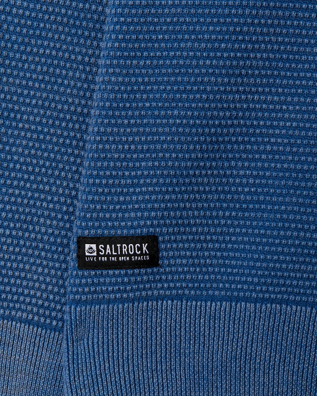 A close up of a Saltrock Moss - Mens Washed Knitted Crew - Blue sweater with a logo on it.