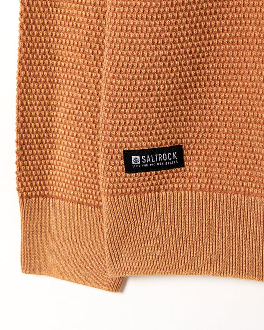A tan cotton sweater with a Saltrock label on it.