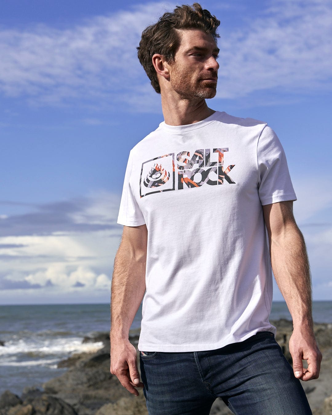 A man wearing a Mountain Logo - Mens Short Sleeve T-Shirt - White, showcasing the Saltrock branding.