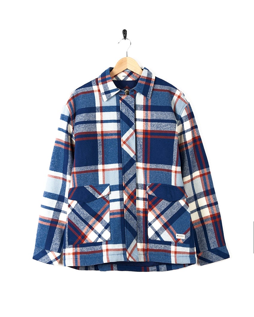 A Saltrock Myla - Womens Hooded Checked Shacket - Blue Check jacket with front pockets hanging on a hanger.