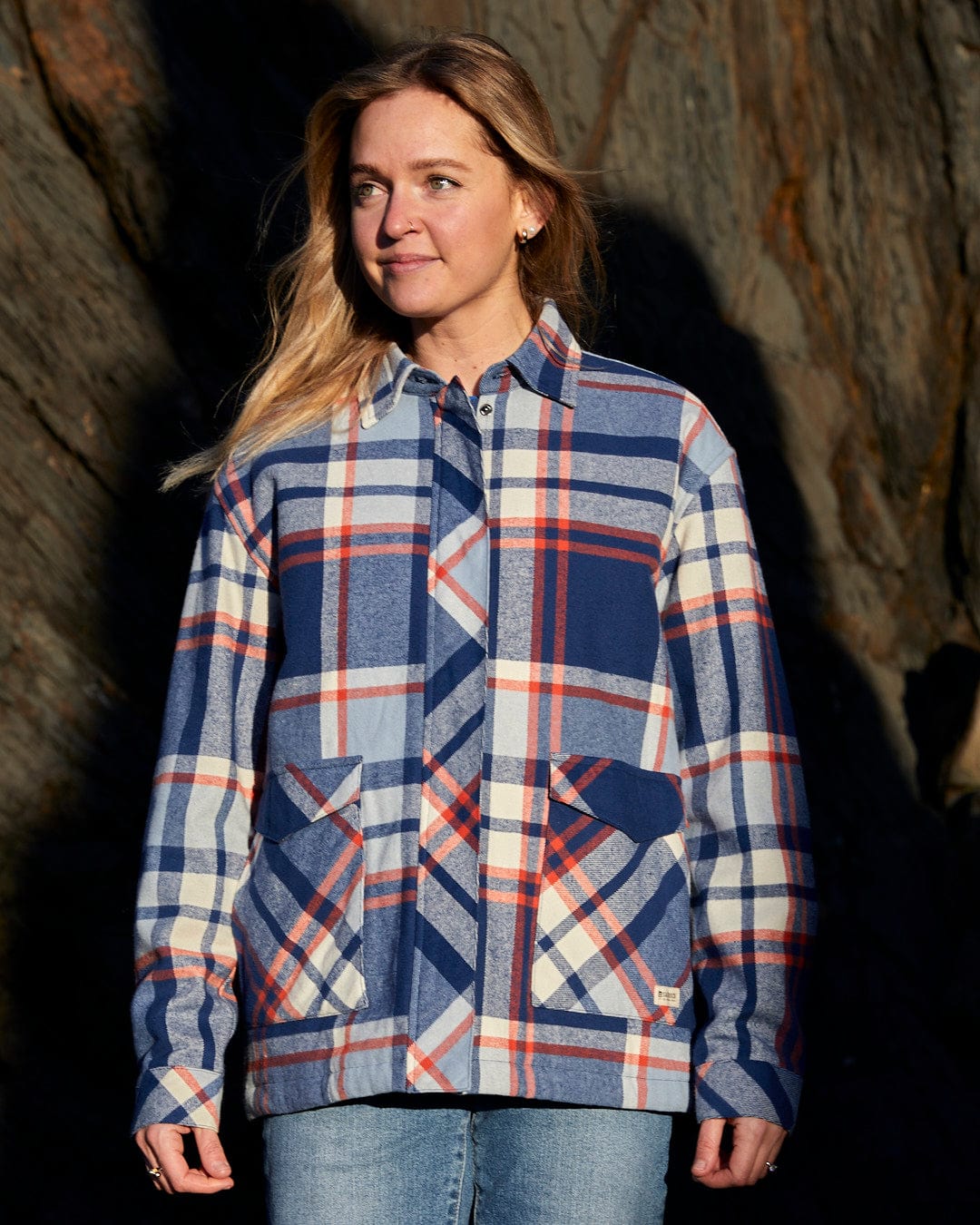 A woman wearing the Saltrock Myla - Womens Hooded Checked Shacket - Blue Check with front pockets.
