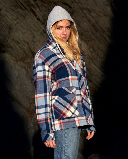 A woman wearing a Saltrock brand Myla - Women's Hooded Checked Shacket - Blue Check with front pockets.
