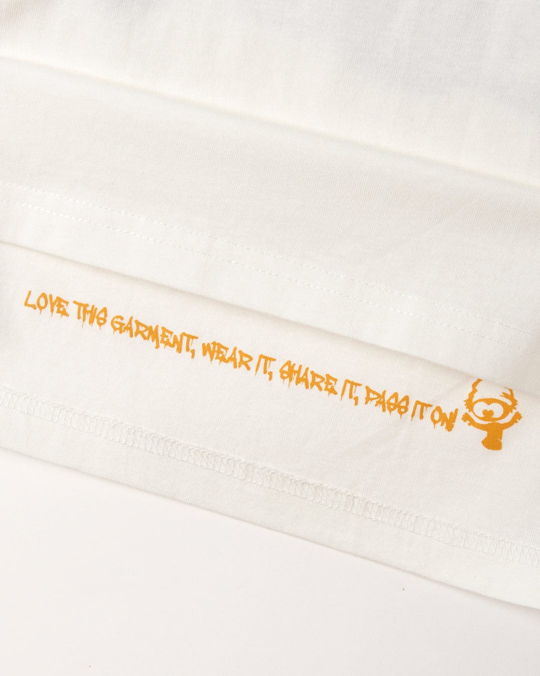 A white Saltrock 100% Cotton t-shirt with orange writing on it.