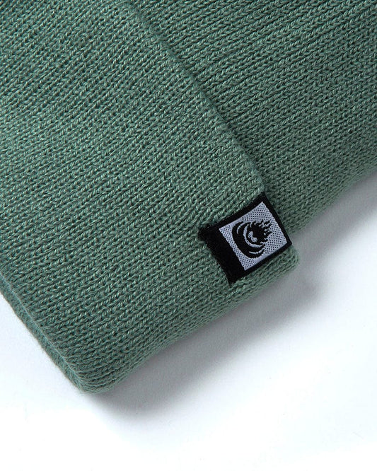 A Saltrock Ok - Tight Knit Beanie - Light Green with a black logo on it.