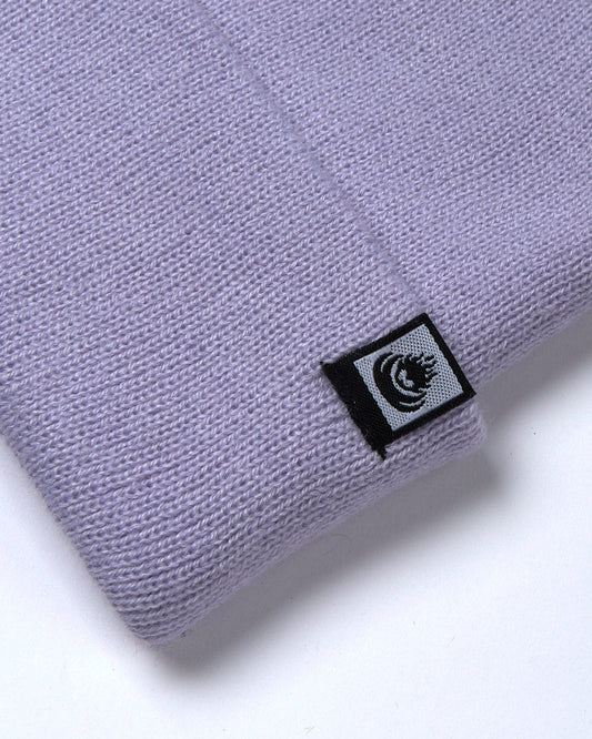 A Saltrock Ok - Tight Knit Beanie - Light Purple with a black logo on it.