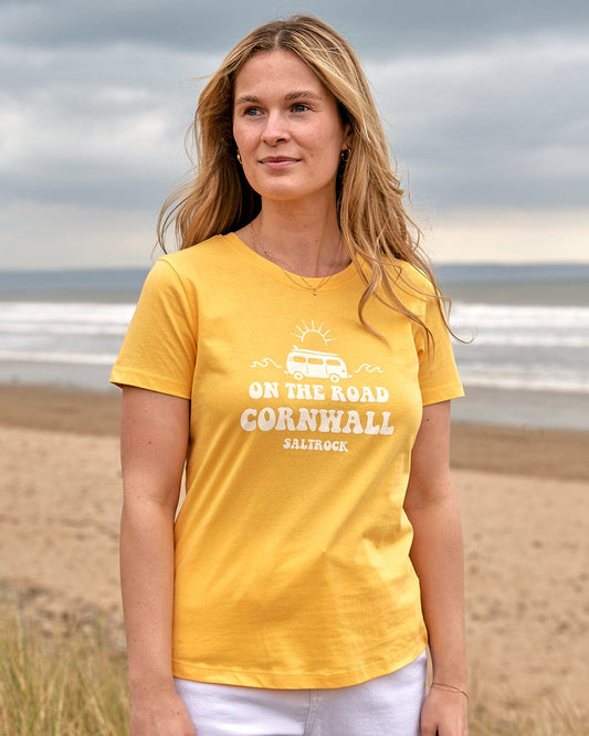 A woman wearing a yellow On The Road Cornwall - Womens Short Sleeve T-Shirt - Yellow, made by Saltrock.