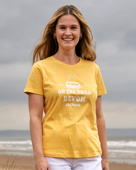 A woman wearing a Saltrock yellow On The Road Devon - Womens Short Sleeve T-Shirt.
