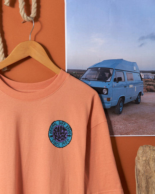 Saltrock SR Originals - Mens Short Sleeve T-Shirt in Peach with a surf-themed badge hanging in front of a photograph featuring a vintage van.
