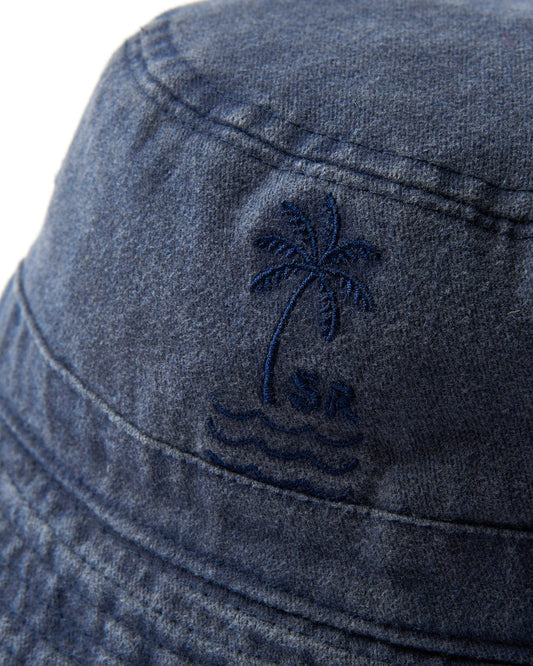 Close-up of a dark blue Palm Bucket Hat with an embroidered palm tree design by Saltrock.