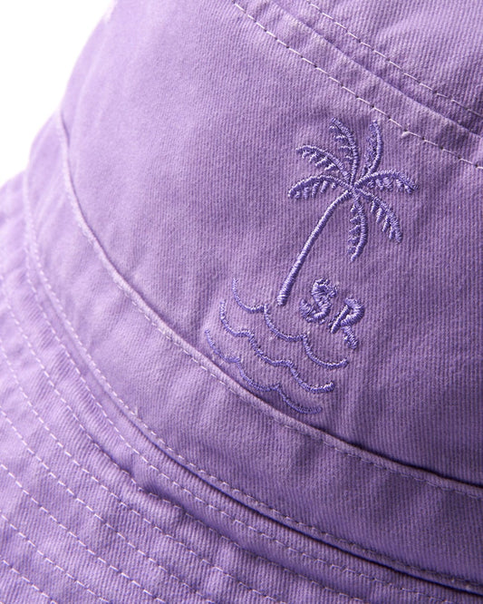 Close-up of a cotton purple Palm Bucket Hat with an embroidered palm tree and waves design by Saltrock.