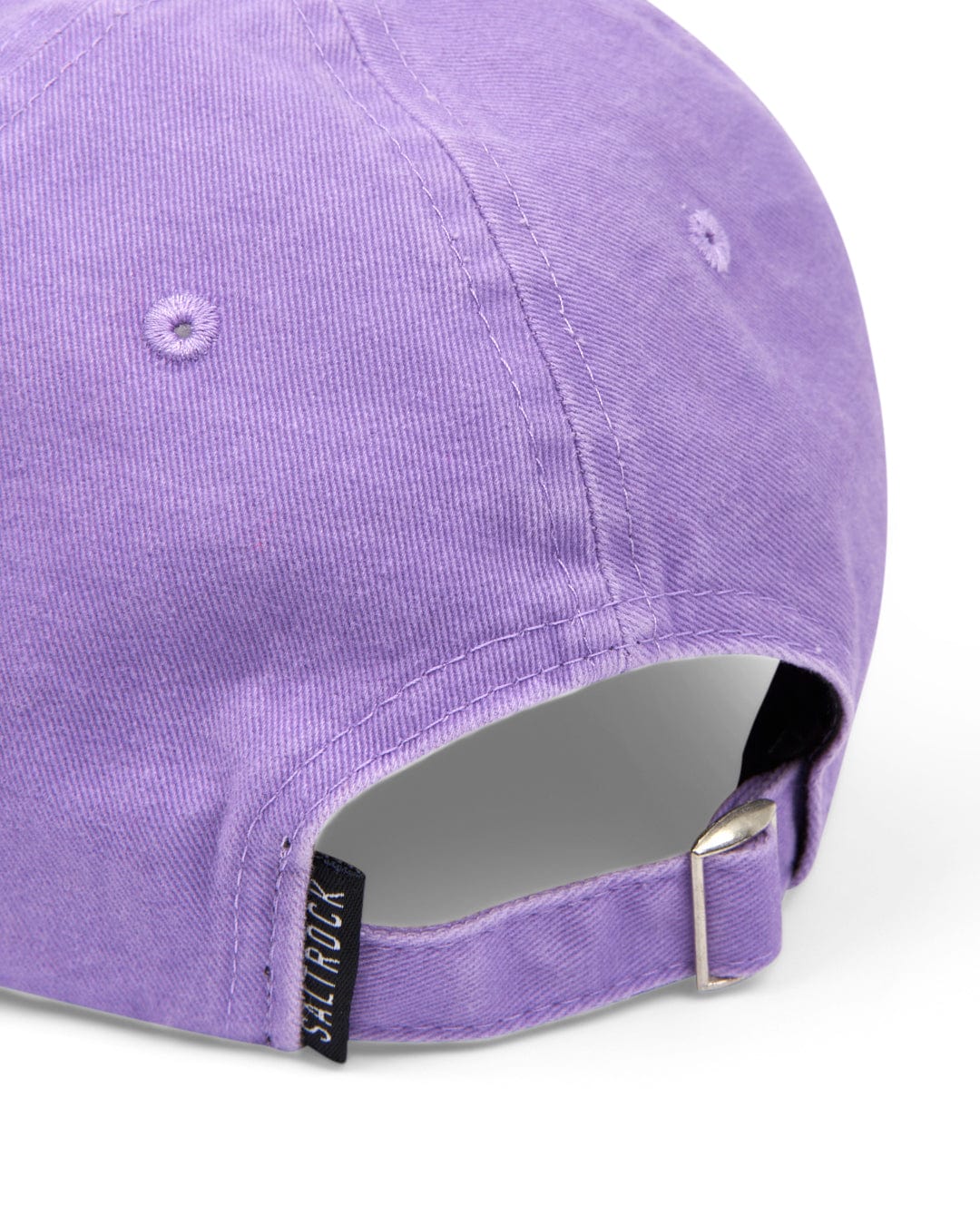 A close-up of a Saltrock Palm Cap - Purple's adjustable strap, featuring Saltrock embroidery.