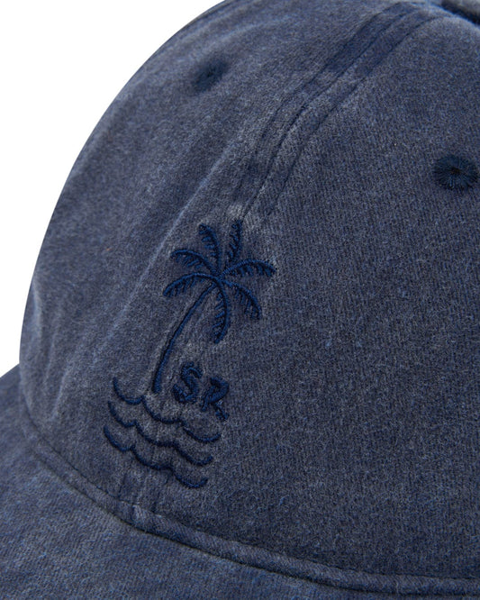 Close-up of a gray Saltrock Palm Cap - Dark Blue with an embroidered palm tree design.