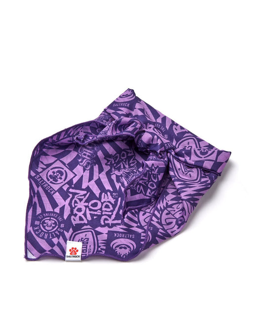 A Saltrock purple branded dog bandana with an all-over white graphical print, folded loosely on a white background.