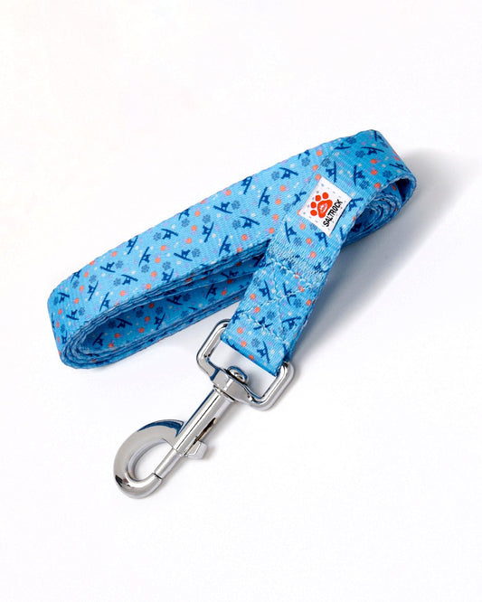 A Saltrock blue dog leash with a surf/paw print pattern and a metal clip.