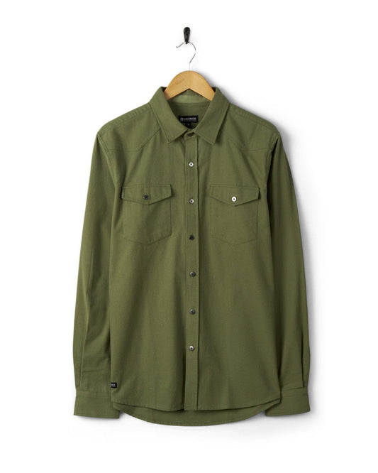 Saltrock's Penare - Mens Long Sleeve Shirt - Green on a hanger against a white background.