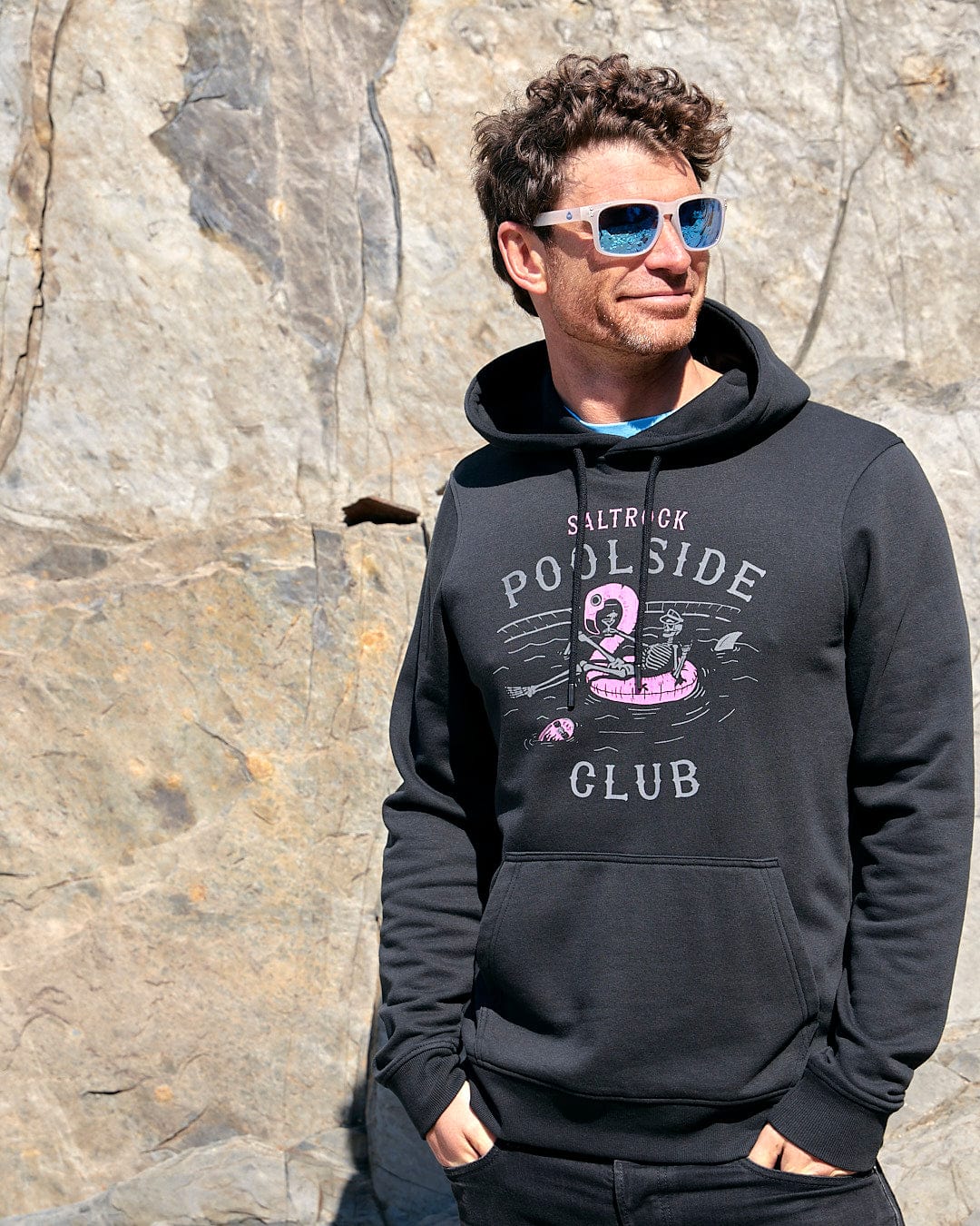 A man wearing a Saltrock Poolside - Mens Pop Hoodie - Black.