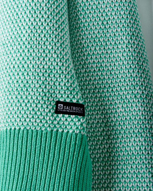 Close-up of a teal and white textured knit garment with a visible "Saltrock" label near the ribbed hem. This is the Poppy - Womens Knitted Pop Hoodie - Green by Saltrock.