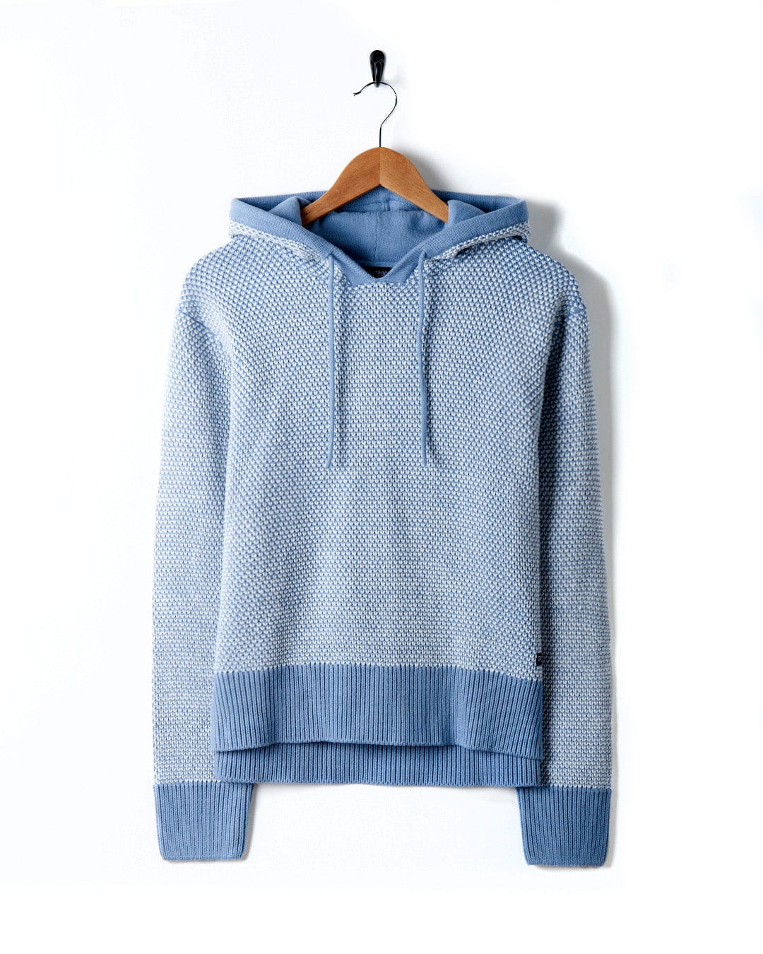 A blue sweater with textured knit, featuring Saltrock branding, on a Poppy - Womens Knitted Pop Hoodie - Blue.