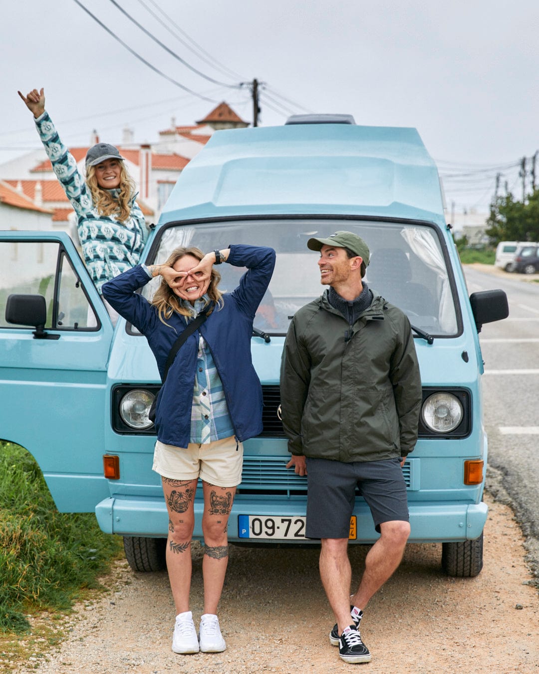 Three friends enjoying a road trip with a vintage blue van, one clad in a Saltrock Portis - Womens Fleece - Green jacket.