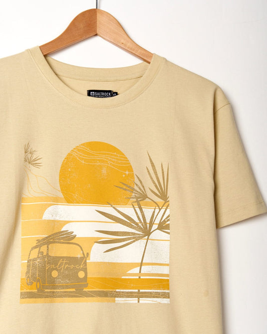 An oversized beige t-shirt featuring a sunset scene with a van and palm trees by Saltrock.
