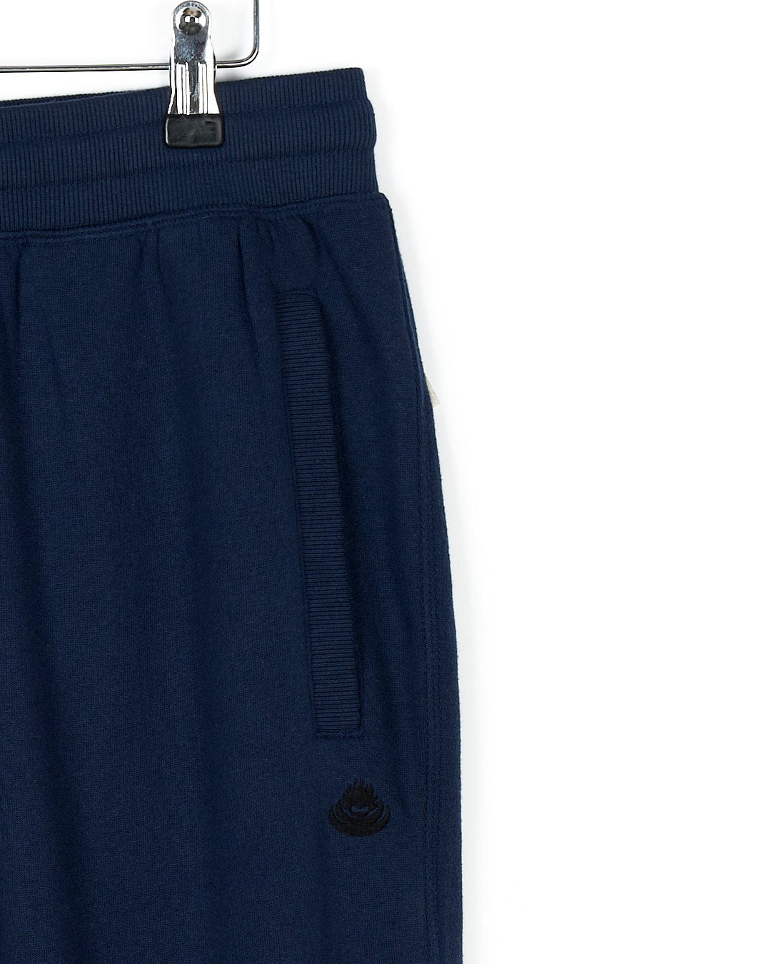 A Saltrock Premium Helston - Mens Jogger - Dark Blue sweatpants hanging on a hanger.