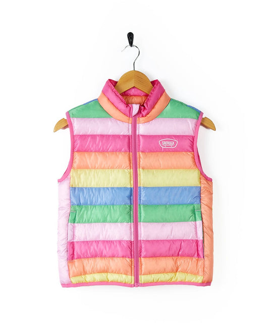 A girl's Rainbow Bright - Kids Gilet - Multi/Pink by Saltrock with front pockets hanging on a hanger.