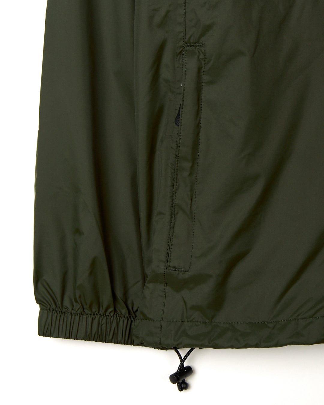 Close-up of a Rainier - Mens Packable Waterproof Jacket in green with an elastic drawstring and toggle on a white background. Brand: Saltrock.