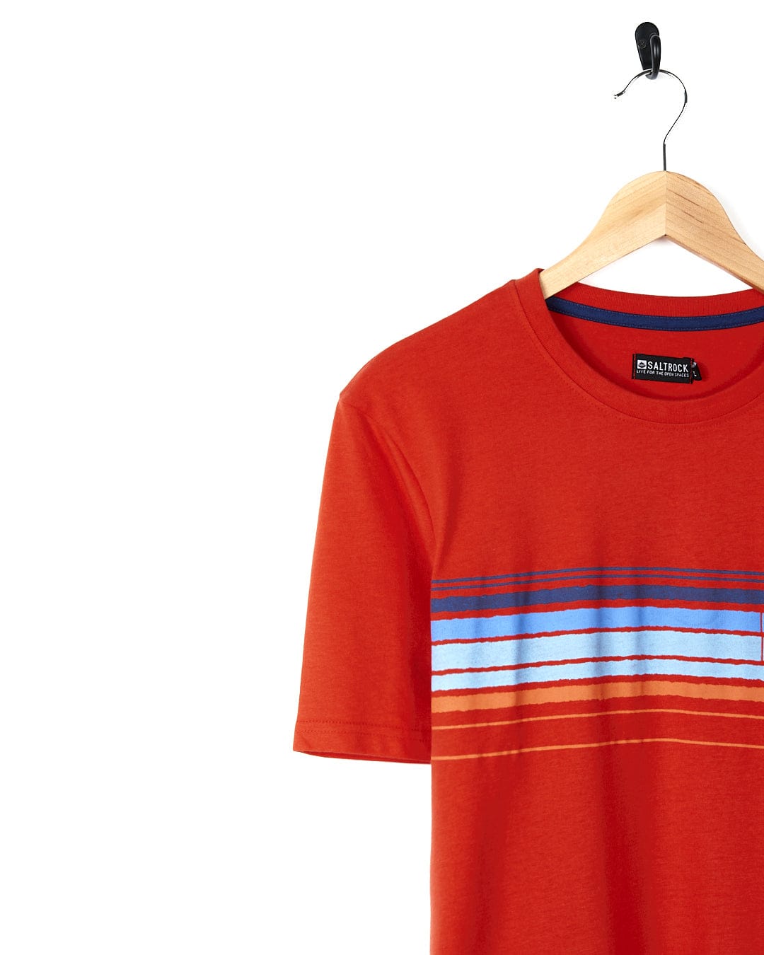 A Saltrock Retro Carve - Mens Short Sleeve T-Shirt - Red with retro stripe design hanging on a hanger.
