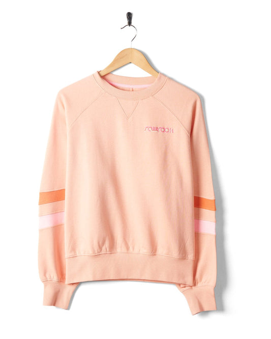 A peach-colored, 100% cotton Retro Ribbon Block sweatshirt with 'Saltrock' embroidered on the chest, hanging on a black hanger against a white background.