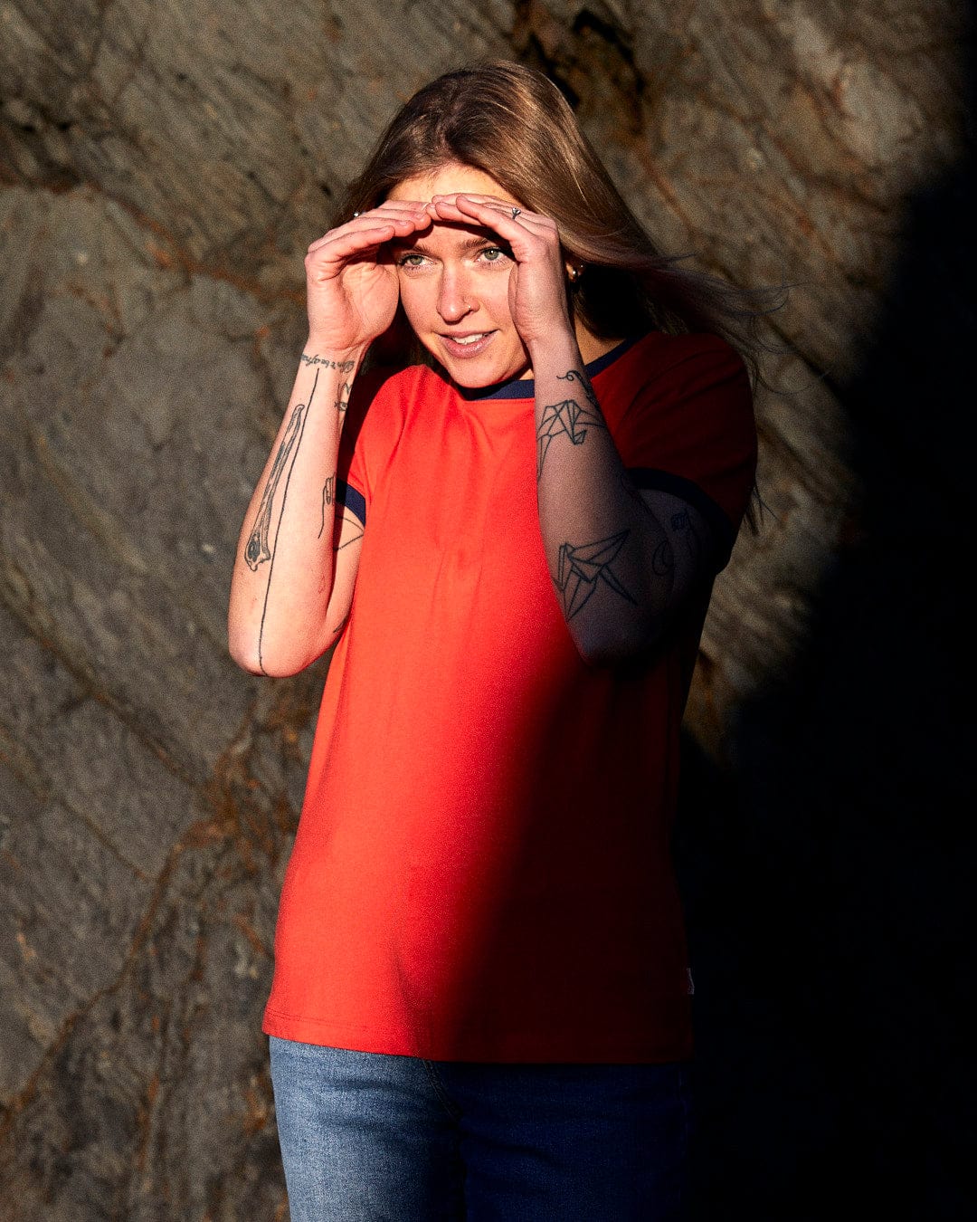 A woman wearing a red Saltrock Retro Wave Mini - Womens Short Sleeve T-Shirt - Red ringer T-shirt.