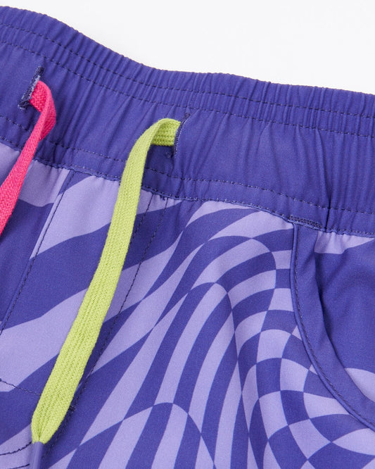 A Saltrock girl's Rezz boardshorts in purple and neon colors with a geometric print.