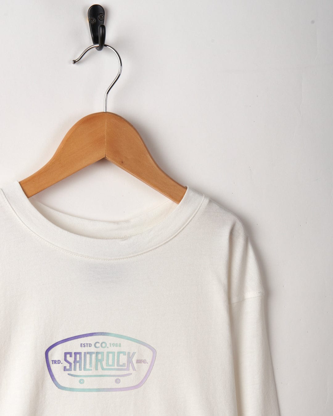 White Rezz Sleeve - Kids Recycled Long Sleeved T-Shirt by Saltrock with a blue logo on a wooden hanger against a plain background.