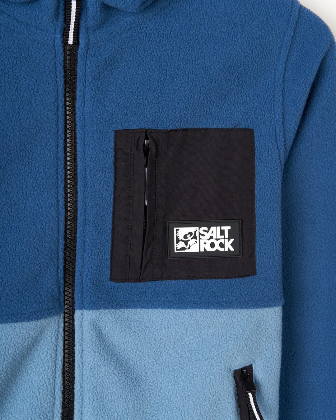 A Saltrock blue Re-Issue - Kids Fleece hoodie with a logo on it and zip pockets.