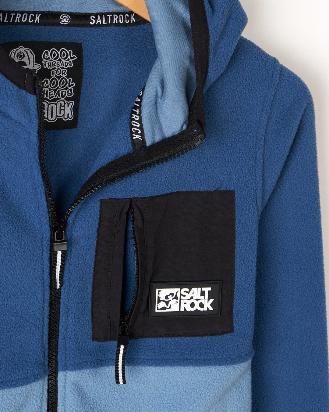 A Saltrock blue and black hoodie with a logo on it, made of Re-Issue - Kids Fleece.