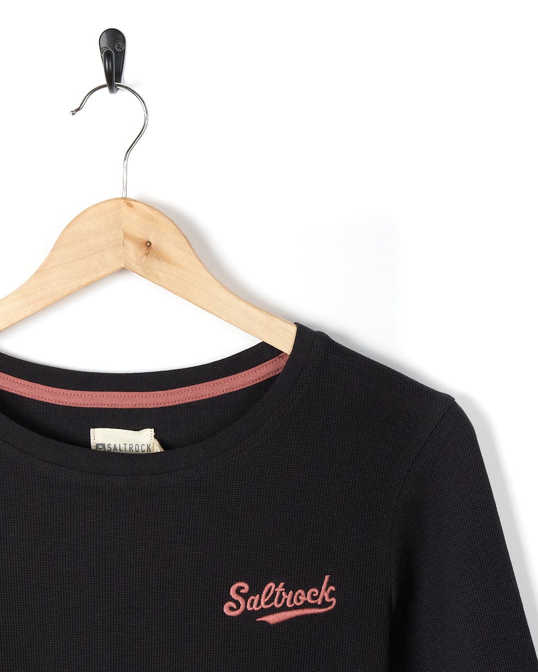 A Saltrock Rory - Womens Long Sleeve Waffle T-Shirt - Black with a pink logo on it.