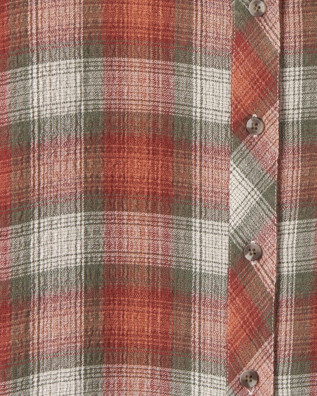 Close-up of a Rosalin long sleeve shirt from Saltrock in shades of orange, white, and green, featuring a row of contrasting buttons.
