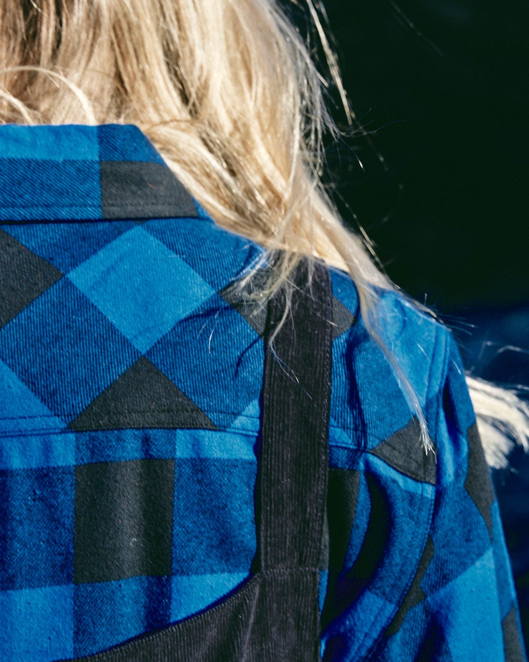 The back of a woman wearing a Saltrock - Rosalin Womens Check Shirt - Blue/Black with buttoned cuffs.
