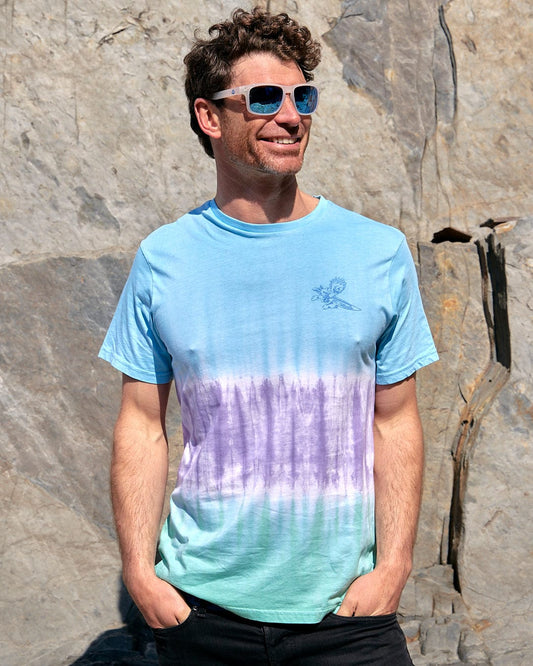 A man wearing sunglasses and a Saltrock Running Man Stripe - Mens Short Sleeve T-Shirt - Tie Dye Blue.