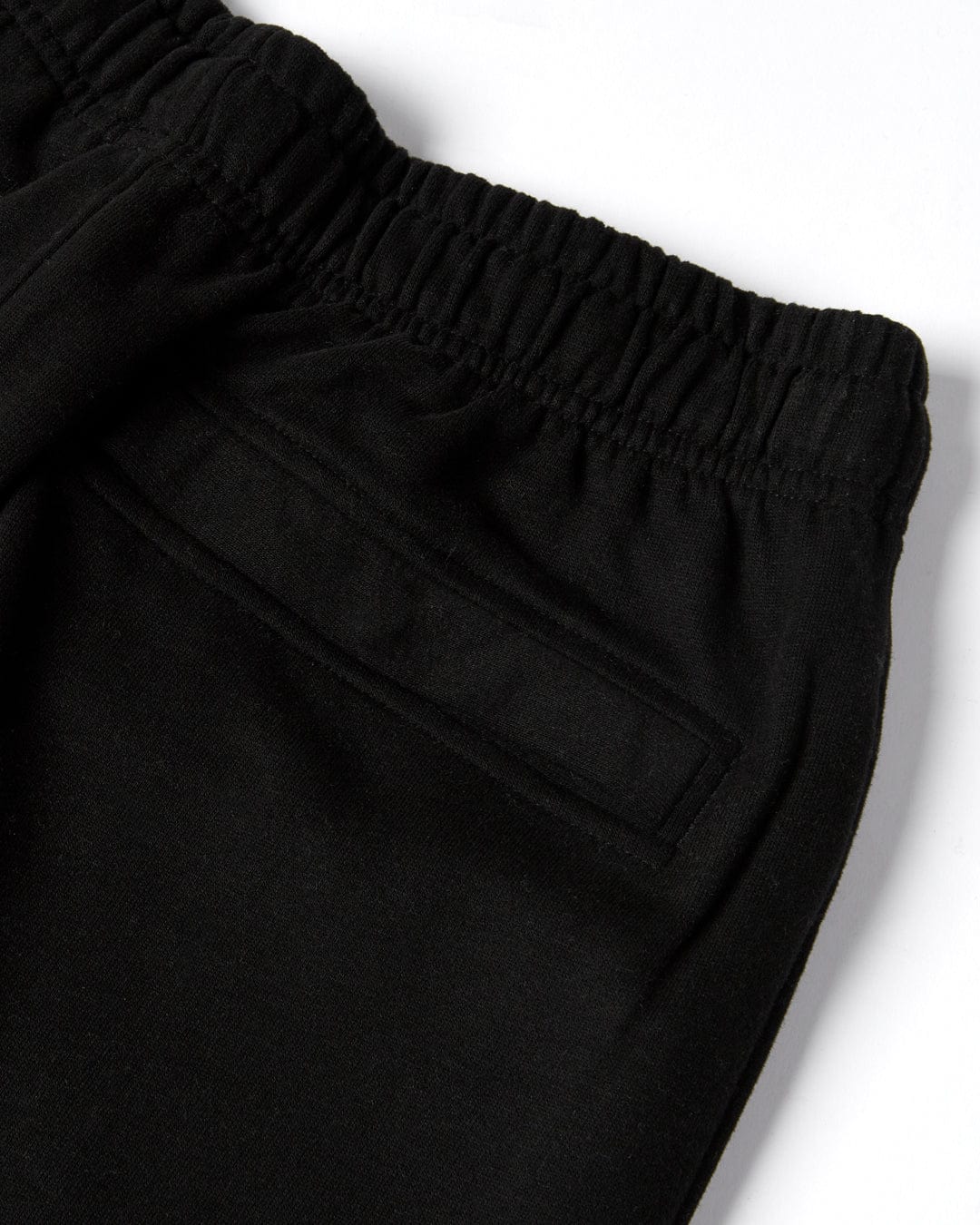 Close-up of a Saltrock Original - Mens Joggers - Black with Saltrock branding, elastic waistband, and pocket detail.