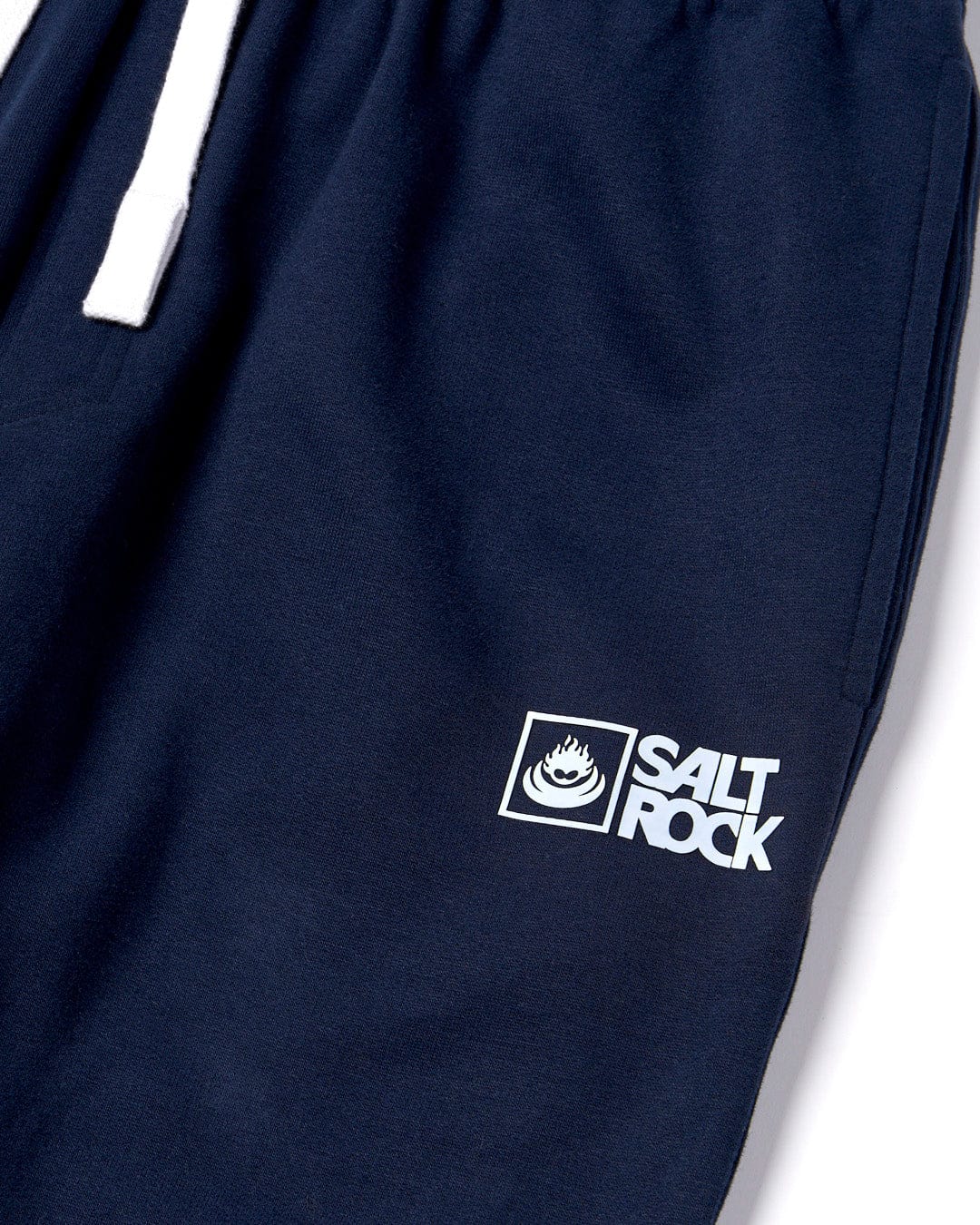 Close-up of a Saltrock Original - Mens Joggers - Dark Blue material with a "Saltrock" logo.