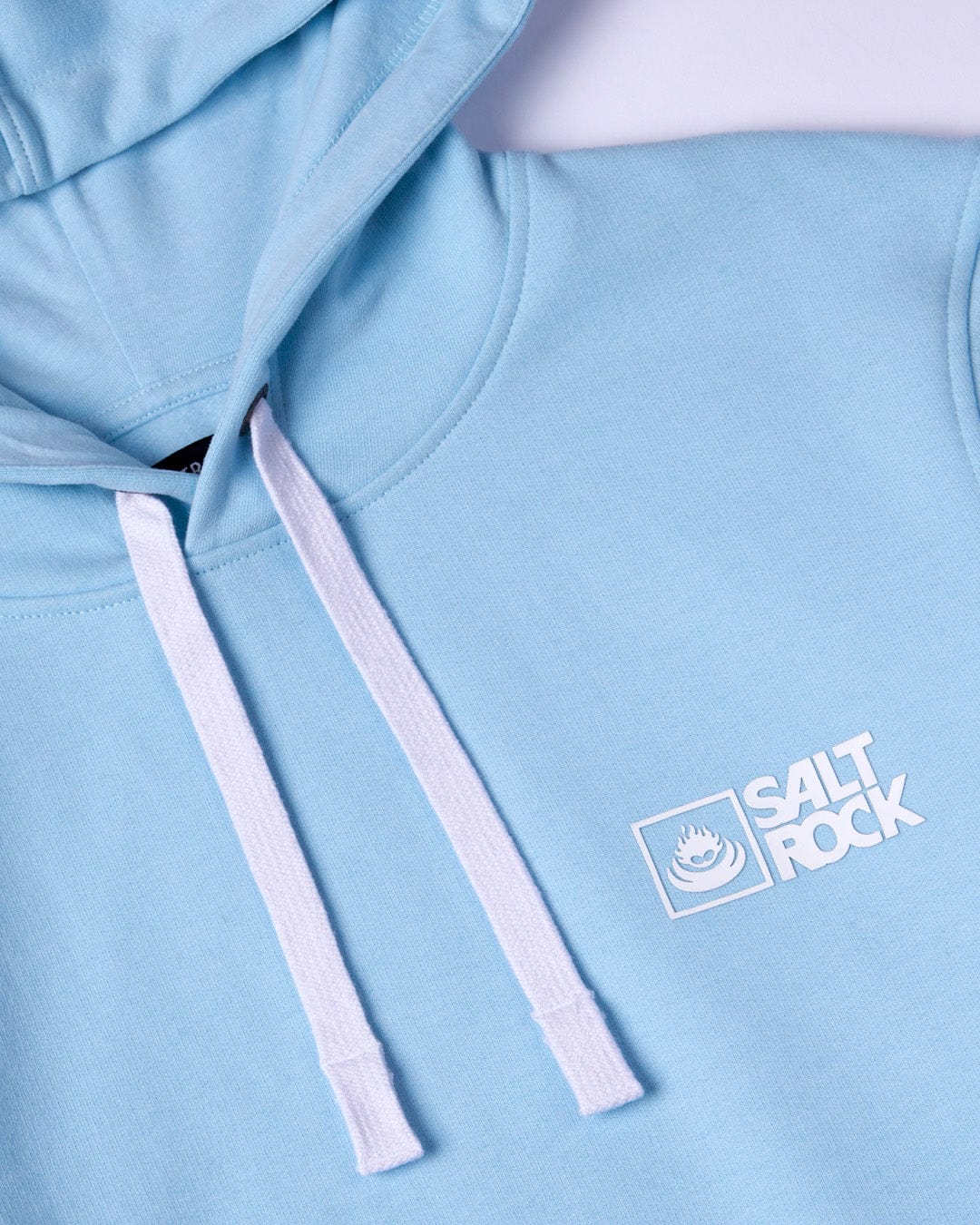 Close-up of a Saltrock Original - Mens Pop Hoodie - Light Blue with a white draw cord hood and Saltrock branding.