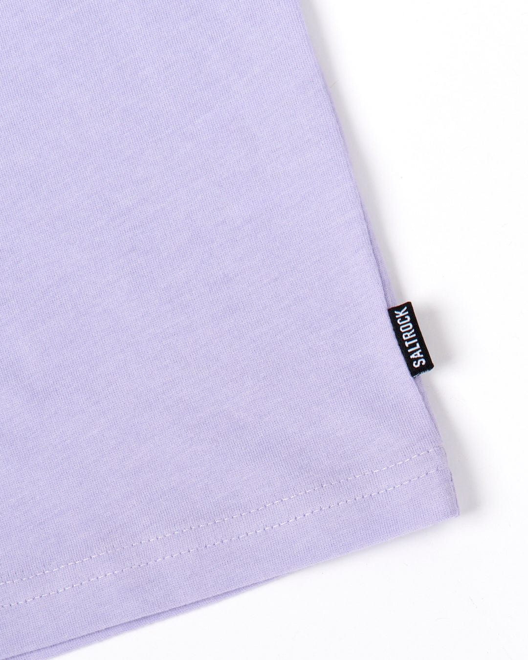 Close-up of a Saltrock Original - Mens Short Sleeve T-Shirt in lilac-colored, lightweight material fabric with a visible seam and a black Saltrock brand label.