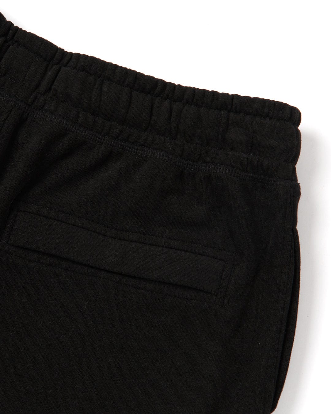 A close-up of Saltrock Original - Mens Short - Black sweatpants with an elasticated waist.