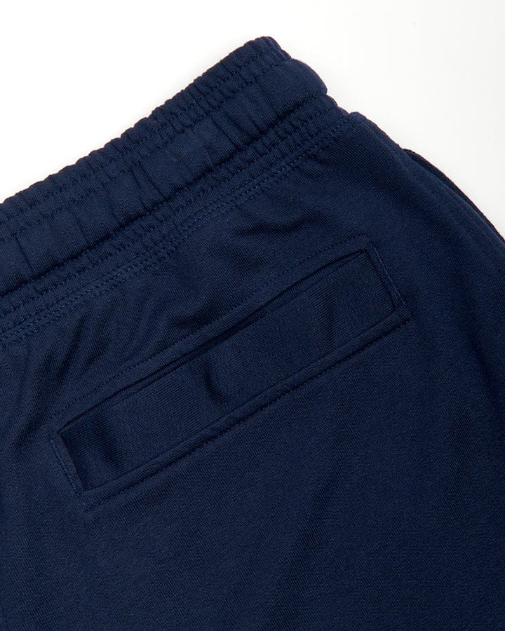 Close-up of a Dark Blue Saltrock Original Mens Sweat Shorts with Saltrock branding, an elasticated waist, and a pocket detail.