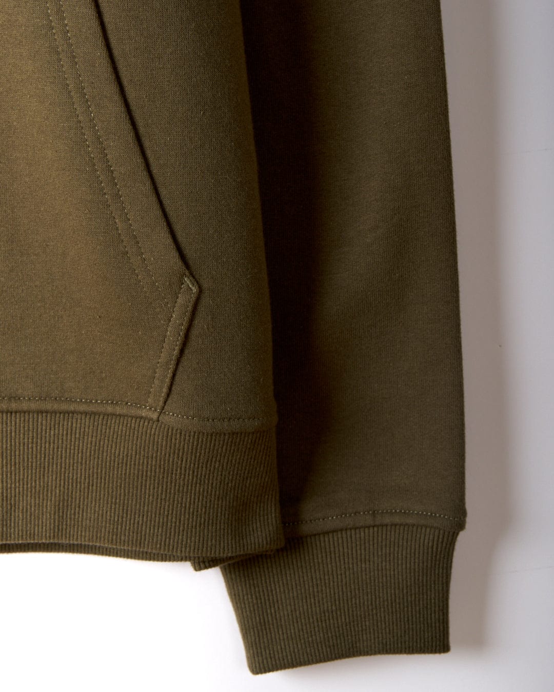 The close-up of the Saltrock Original Men's Pop Hoodie in green displays the right sleeve and pocket. It features soft jersey material, a ribbed cuff and hem, visible stitching, a drawcord hood for functionality, and subtle Saltrock branding to complete the design.