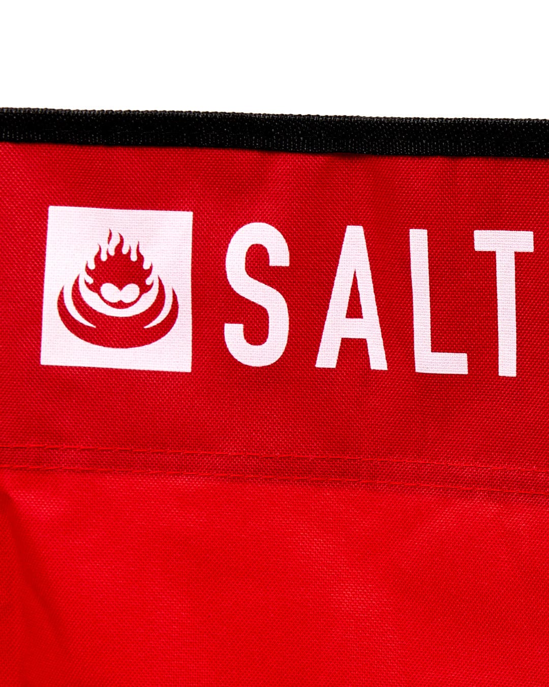 A red, lightweight Sanur - Foldable Beach Chair with the word Saltrock on it.