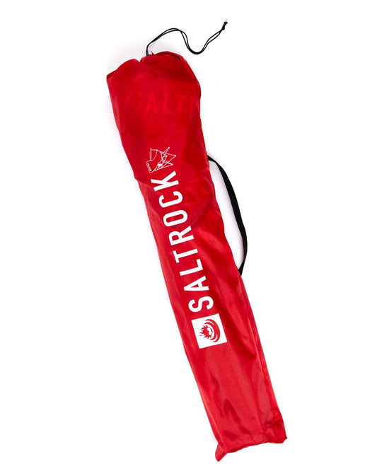 A lightweight Sanur - Foldable Beach Chair - Red bag with the word Saltrock on it.