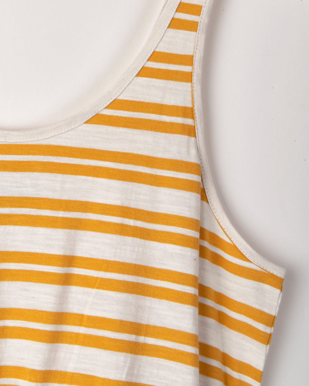 Yellow and white striped sleeveless Skylar Bauhaus dress on a white background by Saltrock.