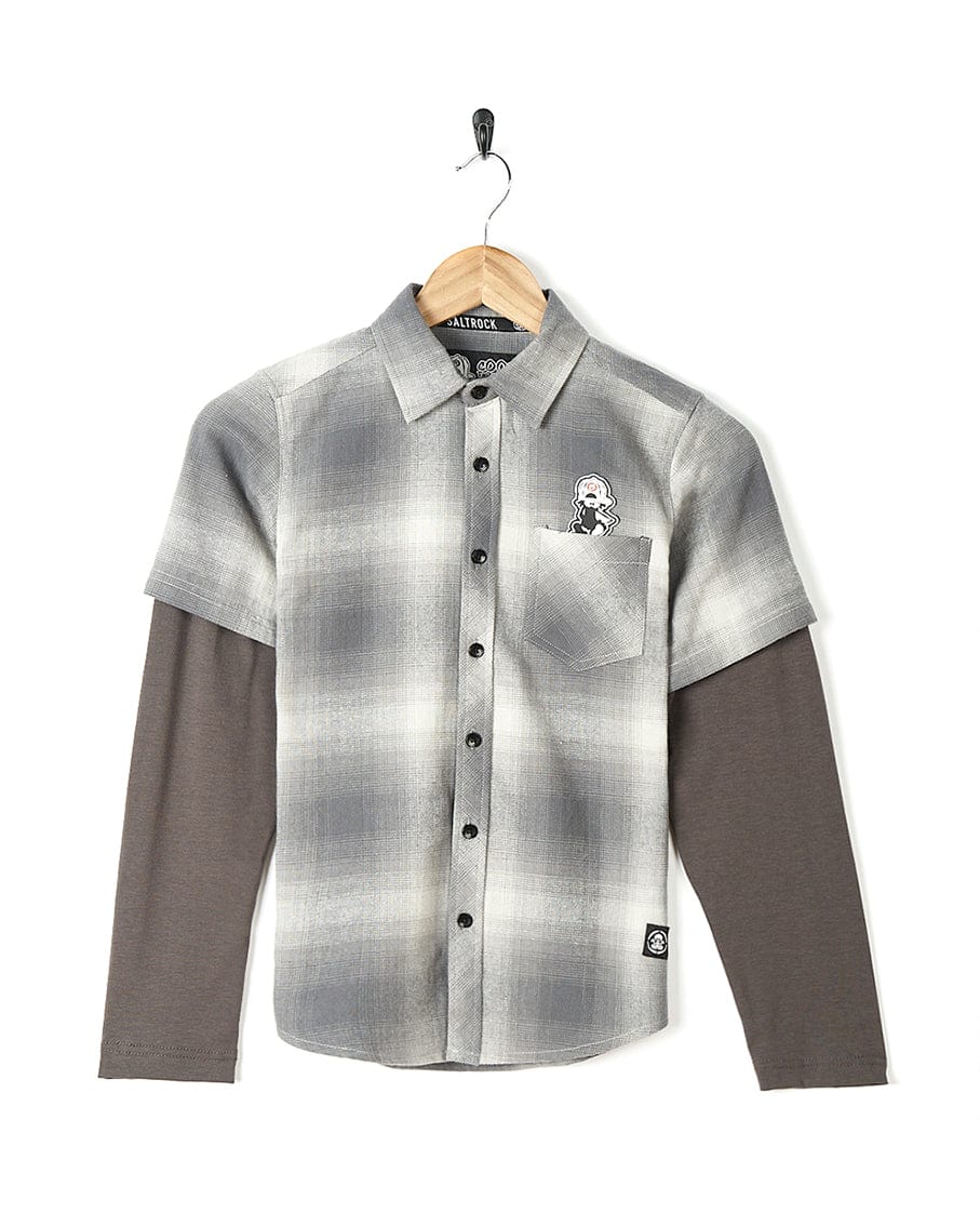 A boy's Saltrock Slacker - Kids Shirt - Grey with a grey and black plaid pattern.